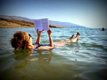 Reading a book in the Dead Sea